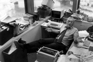 Journalist Mike Royko, lounging at his desk